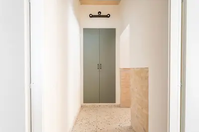 a hallway with a glass door and a mirror at FAMM - Cozy flat in Trastevere in Rome