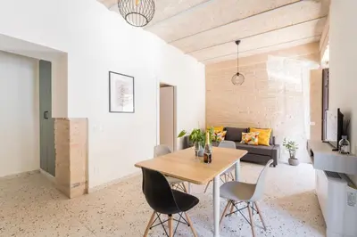 a dining room and living room with a wooden table and chairs at FAMM - Cozy flat in Trastevere in Rome
