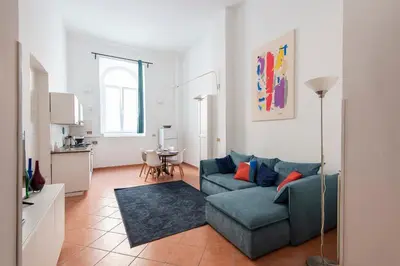 a living room with a couch and a table at Vittorio Elegant Two Bedroom Apartment in Rome