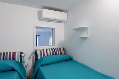 a bedroom with two beds and a window at Vittorio Elegant Two Bedroom Apartment in Rome
