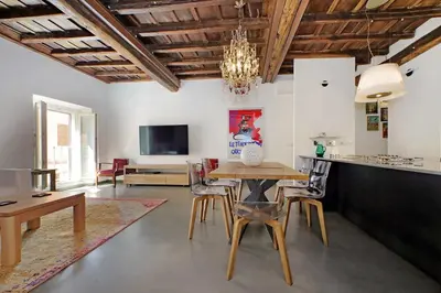 a dining room with a table and chairs at Monti SPQR suite in Rome