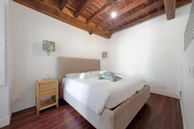 a bedroom with a bed and a wooden ceiling at Monti SPQR suite in Rome