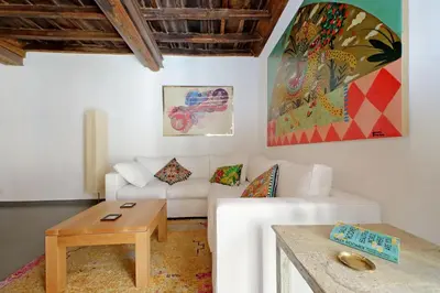 a living room with a white couch and a table at Monti SPQR suite in Rome
