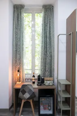 a desk in front of a window in a room at Trastevere Luxury Rooms in Rome