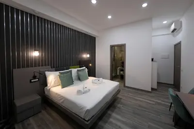 a bedroom with a large bed with two candles on it at Trastevere Luxury Rooms in Rome