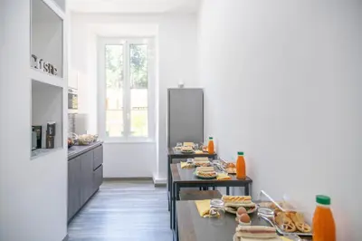 a kitchen with a table with food on it at Trastevere Luxury Rooms in Rome