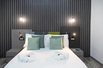 a bedroom with a bed with two towels on it at Trastevere Luxury Rooms in Rome