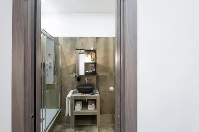 a bathroom with a sink and a mirror at Trastevere Luxury Rooms in Rome