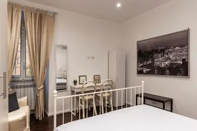 a bedroom with a dining room table and a bed at GuestHost - Sant'Agnese & Nomentana Cozy Apartment in Rome