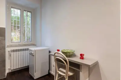 a dining room with a table and a window at GuestHost - Sant'Agnese & Nomentana Cozy Apartment in Rome