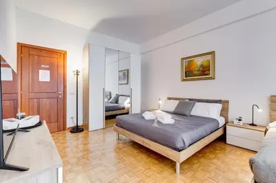 a bedroom with a bed and a living room at DAMA PROPERTY - Trastevere Homestay in Rome