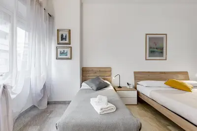 a bedroom with two beds and a window at DAMA PROPERTY - Trastevere Homestay in Rome