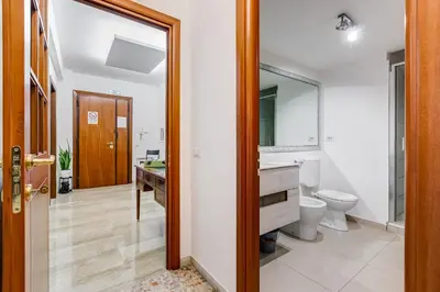 a bathroom with a toilet and a sink and a mirror at DAMA PROPERTY - Trastevere Homestay in Rome