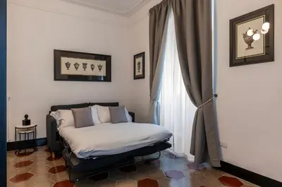 a bedroom with a bed and a window at Toscana 5 - FromHometoRome in Rome