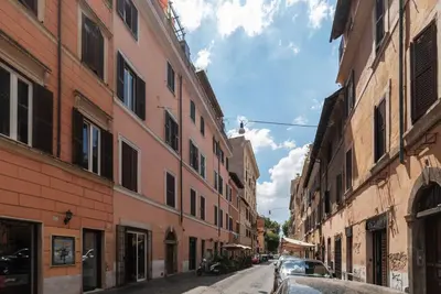 an empty street in an alley with buildings at Cozy Apartment in Trastevere in Rome