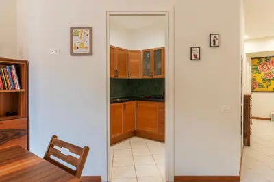 a kitchen with a door leading into a dining room at Cozy Apartment in Trastevere in Rome