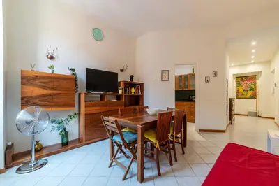 a living room with a wooden table and chairs at Cozy Apartment in Trastevere in Rome