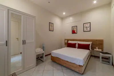 a bedroom with a bed with red pillows at Cozy Apartment in Trastevere in Rome