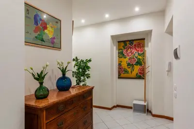 a room with two vases on top of a wooden dresser at Cozy Apartment in Trastevere in Rome