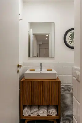 a bathroom with a sink and a mirror and towels at Toscana 2bis - FromHometoRome in Rome