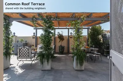 a patio with a table and chairs and plants at Toscana 2bis - FromHometoRome in Rome