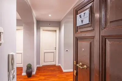 a hallway with a door with a clock on it at The Vatican Dream 3BDR Apartment in Rome