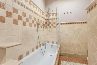 a bathroom with a tub and a shower and a sink at The Vatican Dream 3BDR Apartment in Rome