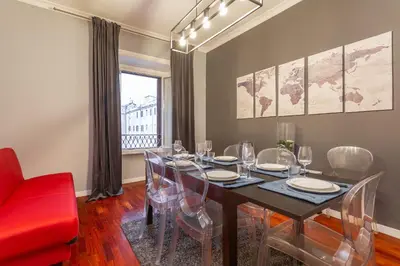 a dining room with a table and chairs at The Vatican Dream 3BDR Apartment in Rome