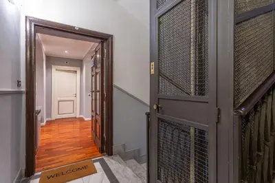 a hallway with an open door with a welcome sign at The Vatican Dream 3BDR Apartment in Rome
