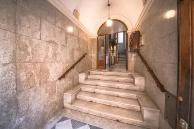 a staircase in a building with a stone wall at Roof Terrace Sophie, Repubblica apartment Termini Station in Rome
