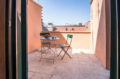 a small table and two chairs on a balcony at Roof Terrace Sophie, Repubblica apartment Termini Station in Rome