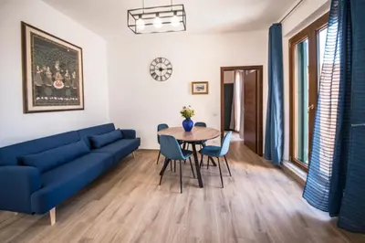 a living room with a blue couch and a table at Roof Terrace Sophie, Repubblica apartment Termini Station in Rome