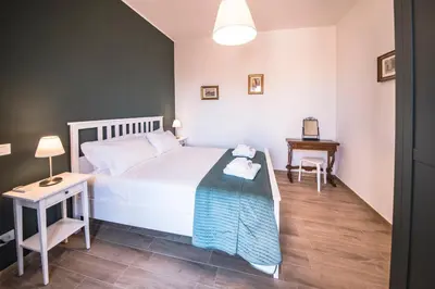a bedroom with a white bed and a table at Roof Terrace Sophie, Repubblica apartment Termini Station in Rome
