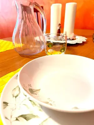 a white bowl and a vase on a table at Everlasting Zen Home in San Giovanni Rome in Rome