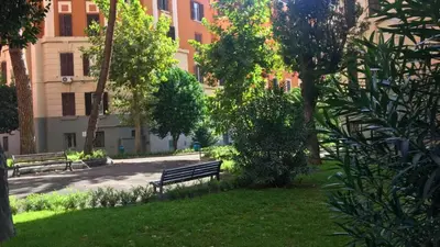 a park with benches and trees and a building at Everlasting Zen Home in San Giovanni Rome in Rome