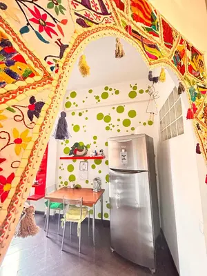 a kitchen with a table and a refrigerator at Everlasting Zen Home in San Giovanni Rome in Rome