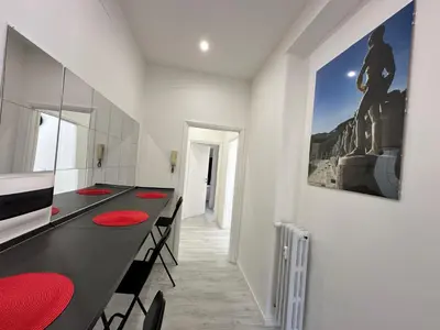 a dining room with a long table with red chairs at St Pietro city center near subway in Rome