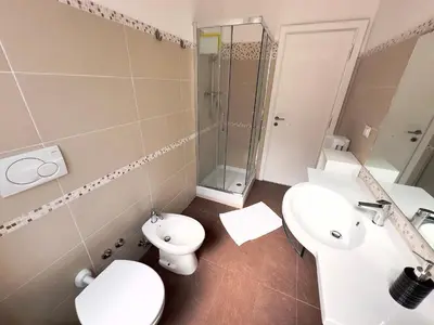 a bathroom with a sink and a toilet and a shower at St Pietro city center near subway in Rome