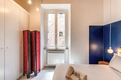 a bedroom with a bed and a window at Trastevere Vicolo del Leopardo suite in Rome