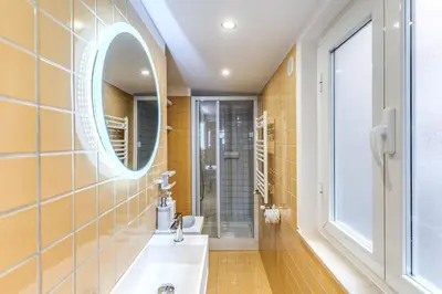 a bathroom with a sink and a mirror at Trastevere Vicolo del Leopardo suite in Rome