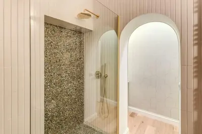 a bathroom with a walk in shower next to a mirror at 3 bedroom apartment Via Genova Monti area in Rome