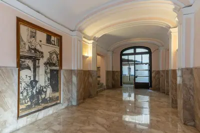 an ornate hallway with paintings on the walls and a doorway at 3 bedroom apartment Via Genova Monti area in Rome