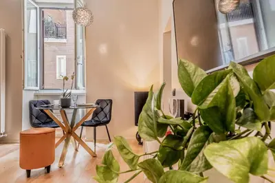 a living room with a table and a plant at Augusto Imperatore Luxury Suite in Rome