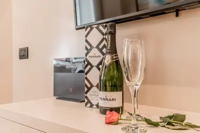 a bottle of wine and a glass on a counter at Augusto Imperatore Luxury Suite in Rome
