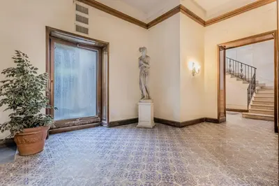 a room with a statue in the corner of a building at Augusto Imperatore Luxury Suite in Rome