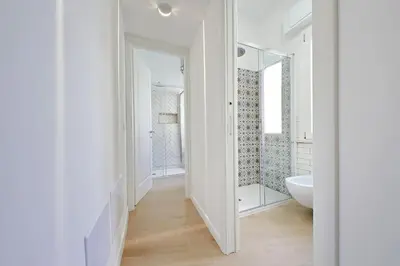 a white bathroom with a sink and a mirror at YCH-La tua casa dei sogni al Vaticano in Rome
