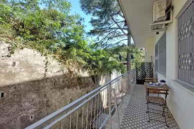 a balcony with a table and chairs on a wall at YCH-La tua casa dei sogni al Vaticano in Rome