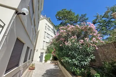 a bush with pink flowers next to a building at YCH-La tua casa dei sogni al Vaticano in Rome