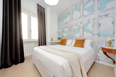 a bedroom with a large white bed and a window at YCH-La tua casa dei sogni al Vaticano in Rome