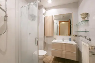 a bathroom with a shower and a toilet and a sink at Conti Ripetta house in Rome